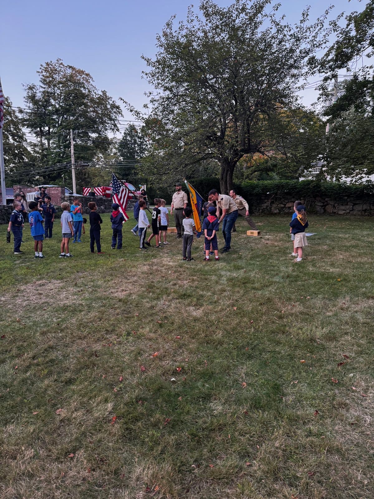 The pack gathered in a circle on the lawn at dusk