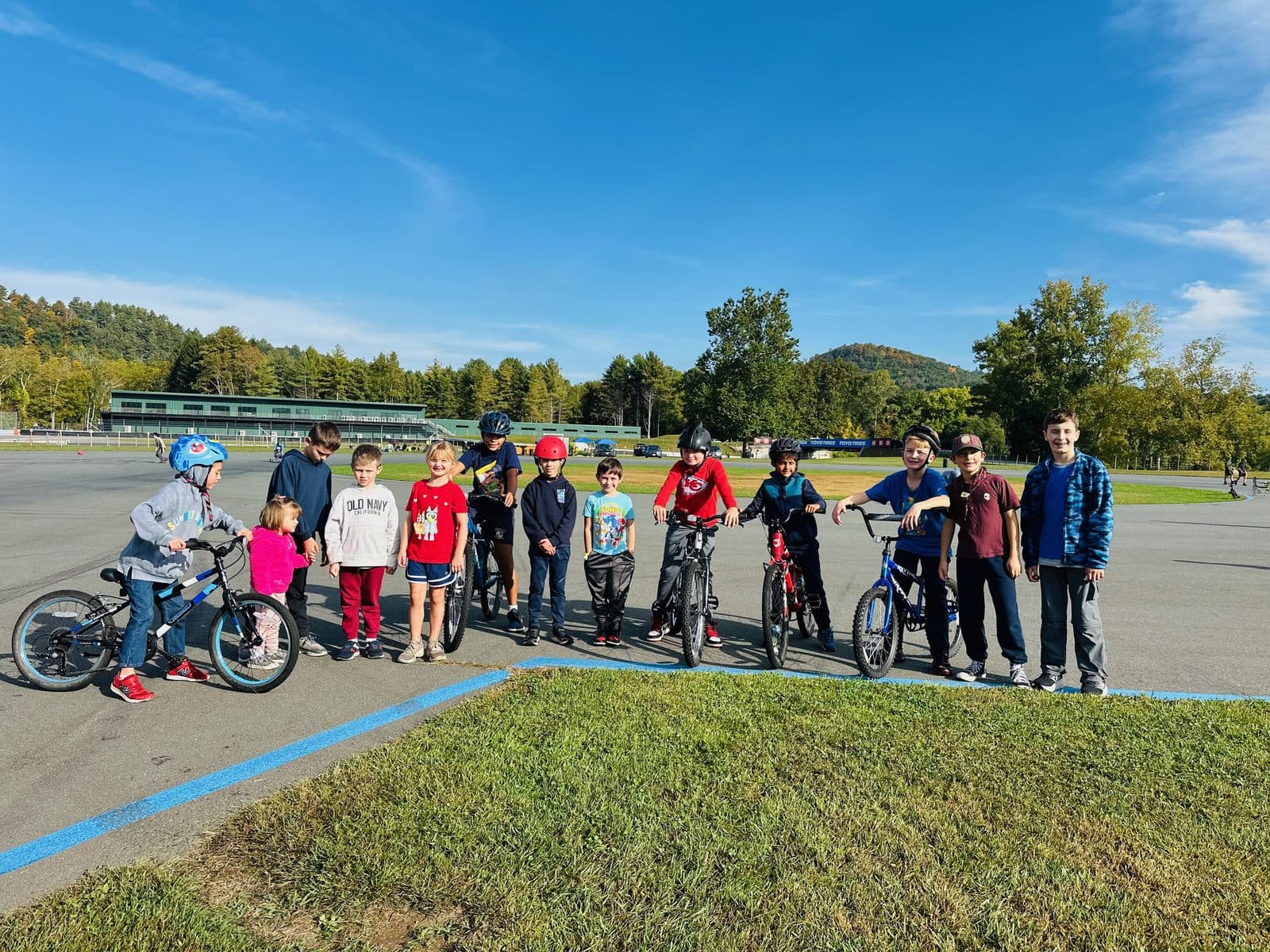 The whole pack lined up with their bikes on the Lime Rock raceway